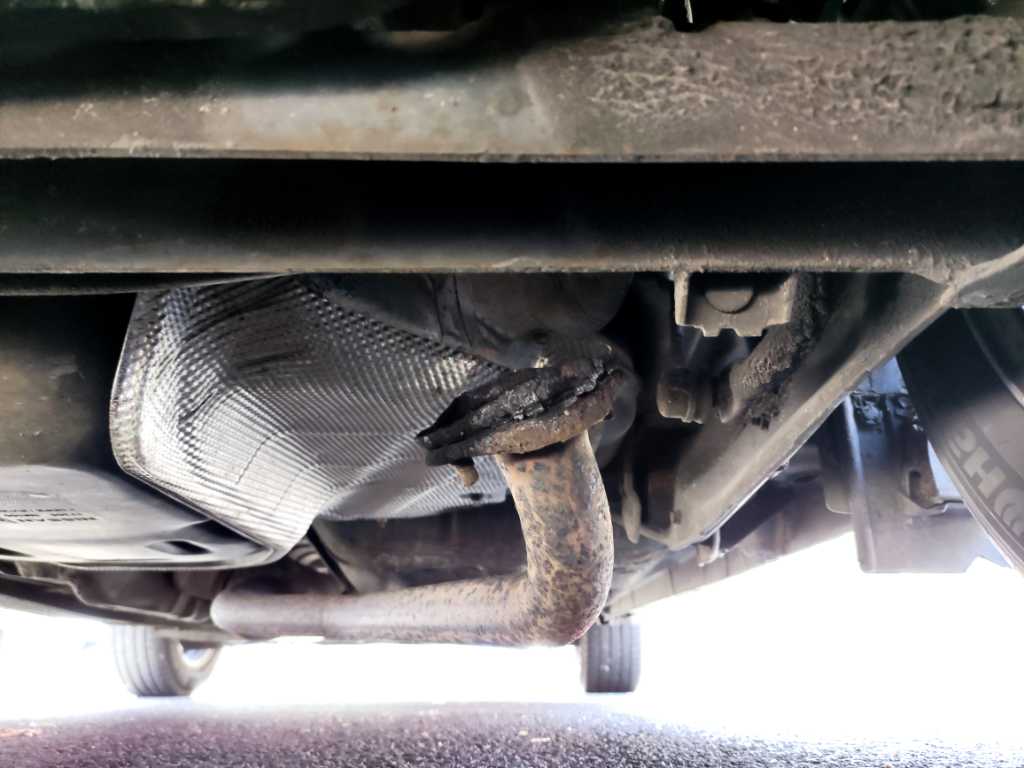 Loose exhaust pipe under car